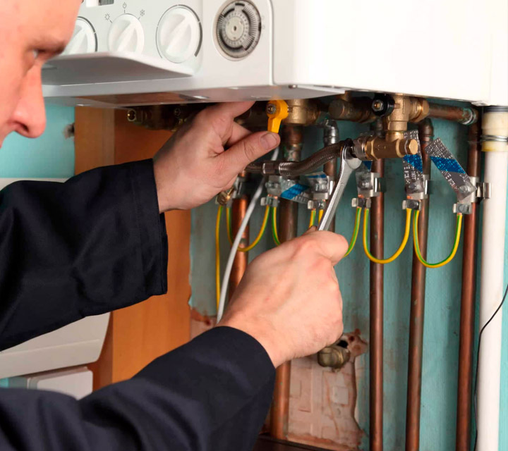 A photo of our technician repairing a boiler