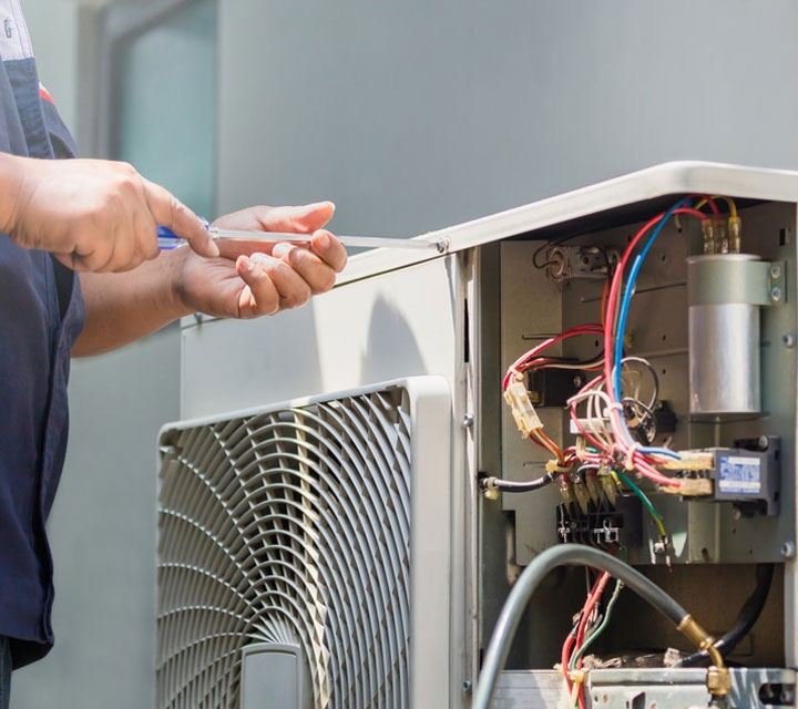 Technician Preforming Air Conditioner Repair