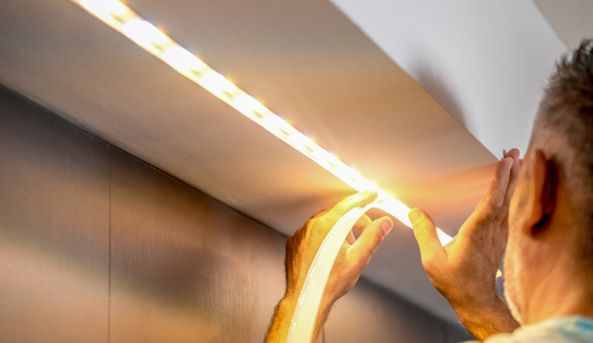 Installing led strip for lighting correctly on the surface of the Cabinet on the kitchen set Installing led strip for lighting correctly on the surface of the Cabinet on the kitchen set